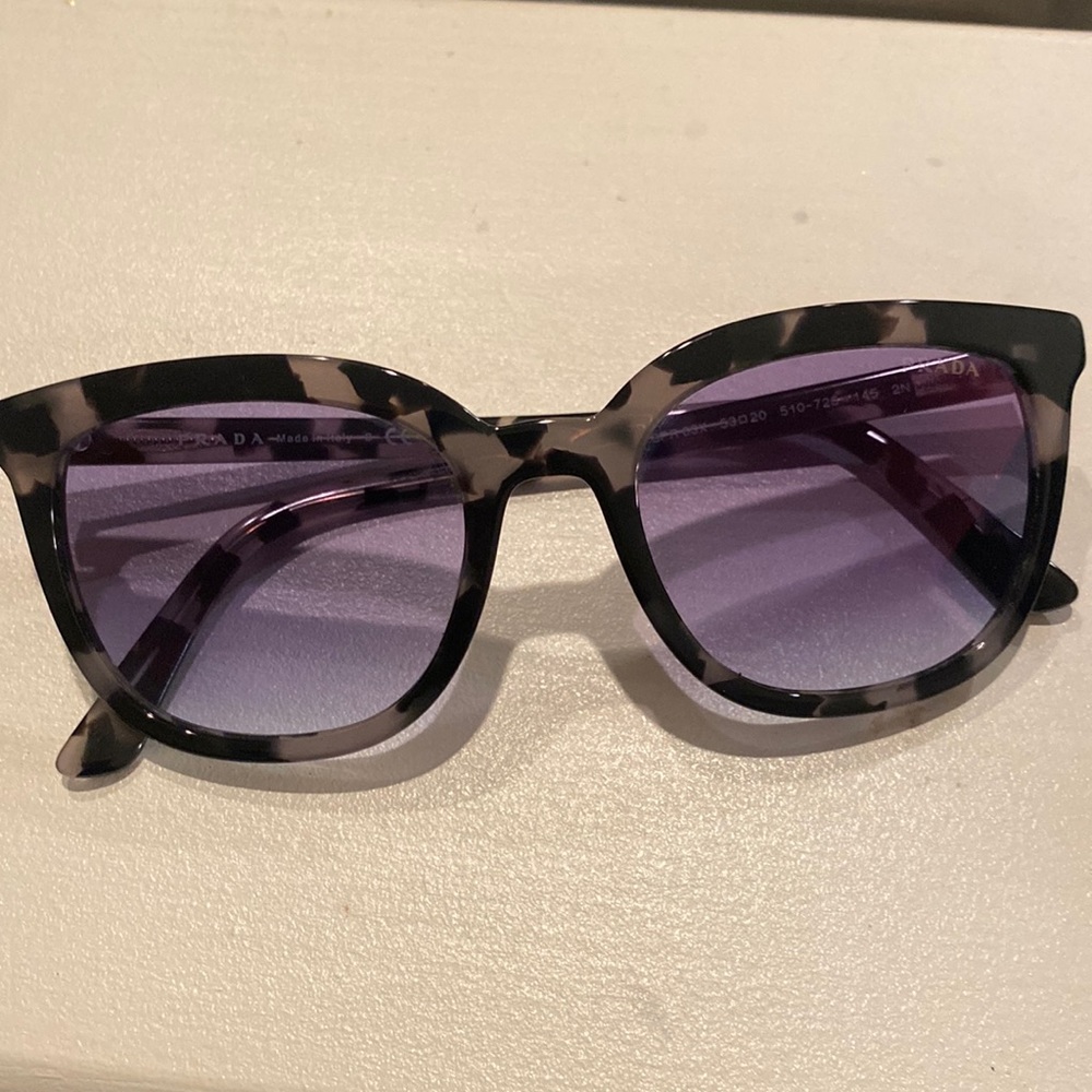 Prada sunglasses with original packaging and box.
